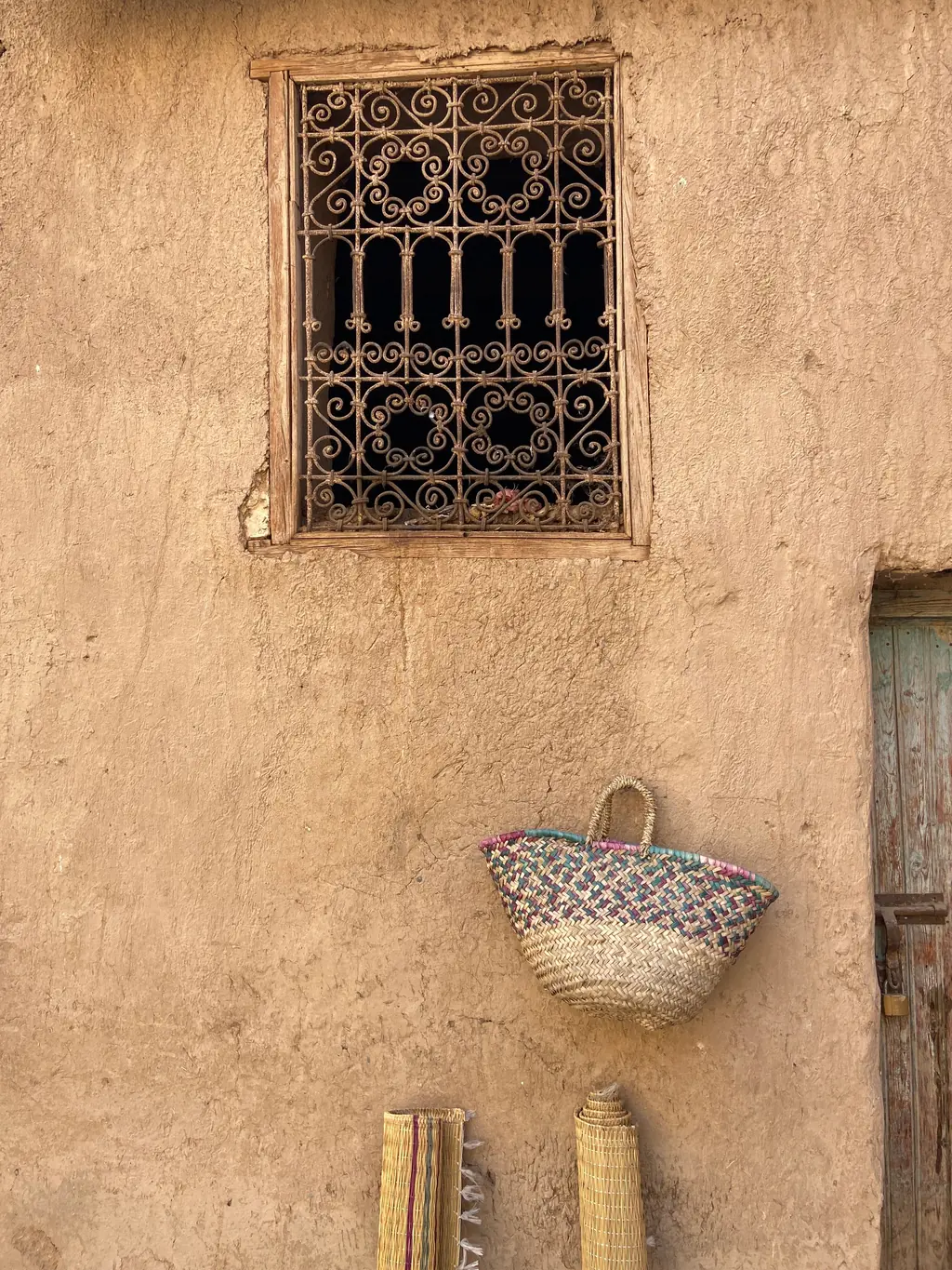 Mud-brick wall, window and woven baskets in Taroudant