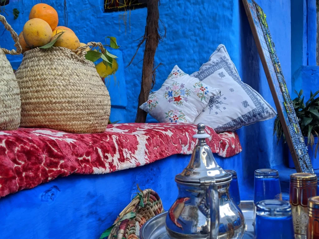 Narrow alleyway in Chefchaouen with blue-painted buildings and staircases