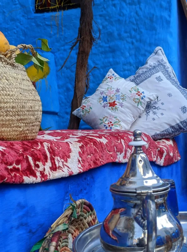 Narrow alleyway in Chefchaouen with blue-painted buildings and staircases