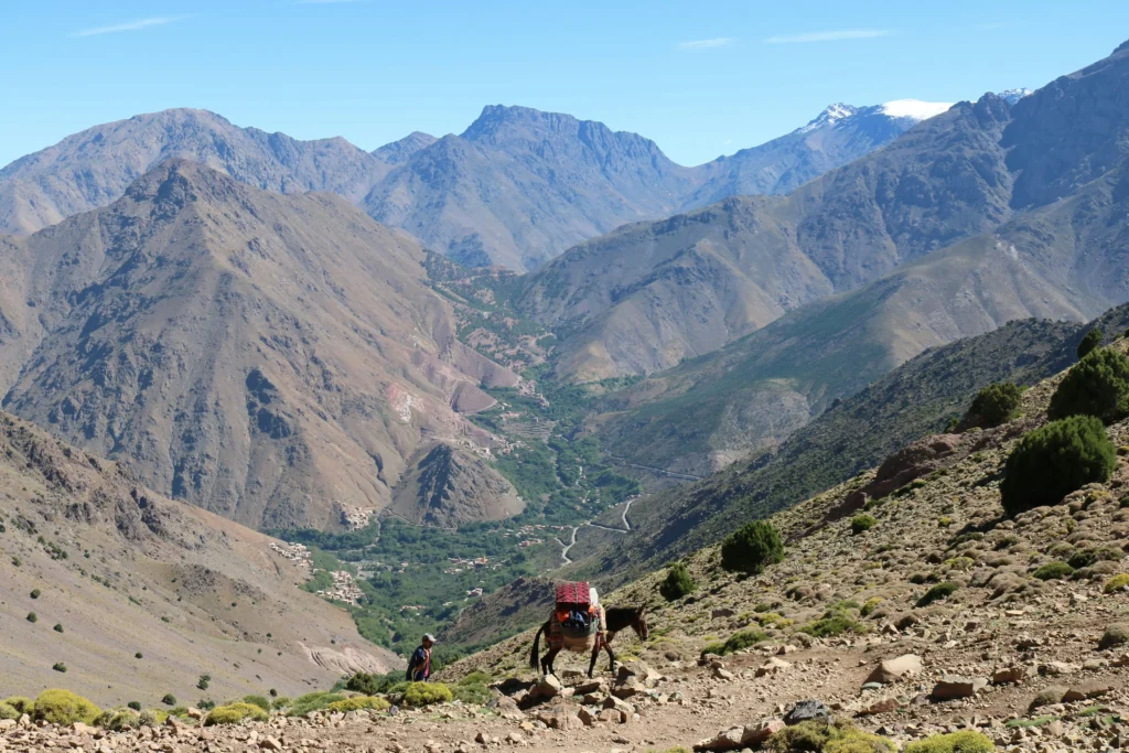 A hiker trekking through rugged Atlas Mountains near Mount Toubkal