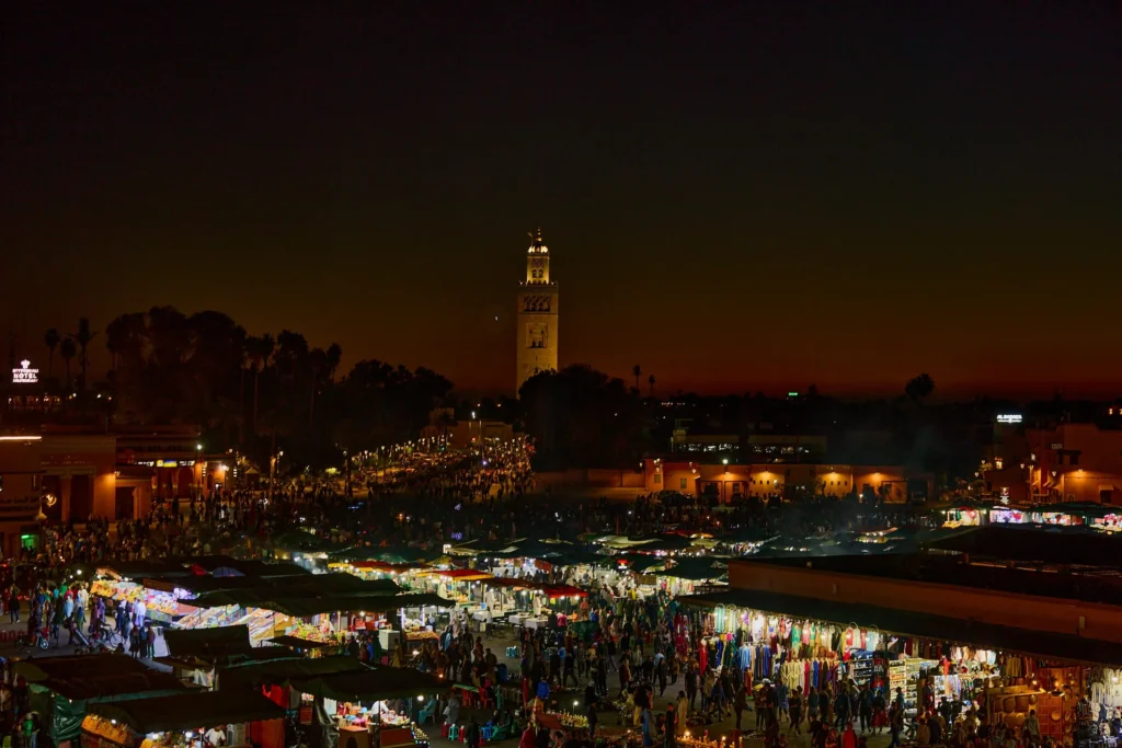 Jemaa el-Fnaa square at night with food stalls and performers in Marrakech, Morocco