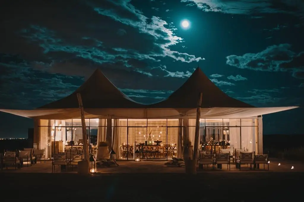 "Agafay luxury camp The White Camel Lodge infinity pool desert sunset Morocco