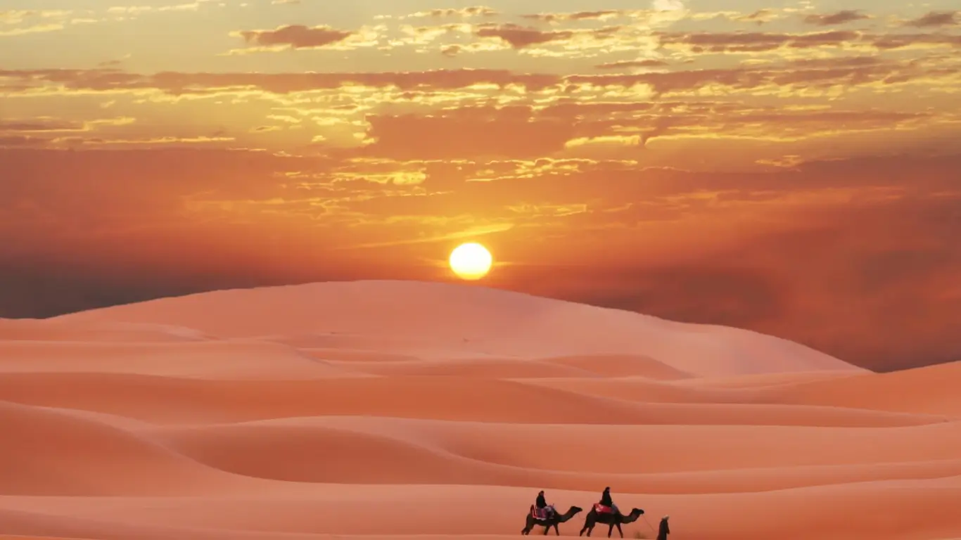 Morocco luxury tour exploring desert dunes at sunset