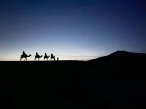 Morocco travel guide showcasing stunning Sahara Desert dunes at golden hour sunset